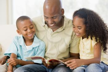 Royalty Free Photo of a Man Reading to His Children