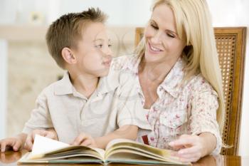 Royalty Free Photo of a Woman Reading to Her Son