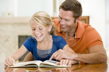 Royalty Free Photo of a Man Reading With His Daughter