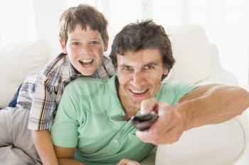 Royalty Free Photo of a Man and a Boy With a Remote