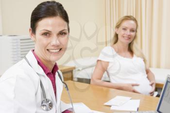 Royalty Free Photo of a Doctor and a Pregnant Woman