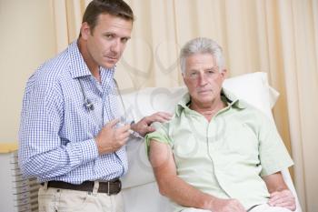 Royalty Free Photo of a Doctor Giving a Man a Needle