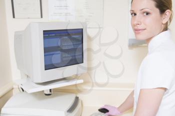Royalty Free Photo of a Dental Assistant at a Computer