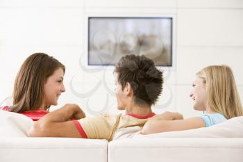 Royalty Free Photo of a Guy and Two Girls on a Couch