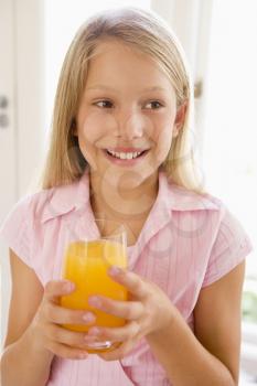 Royalty Free Photo of a Girl With a Glass of Orange Juice