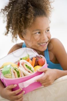 Royalty Free Photo of a Young Girl With Her Lunchbox