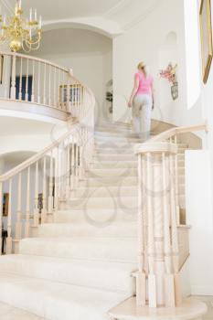 Royalty Free Photo of a Woman Going Up a Staircase