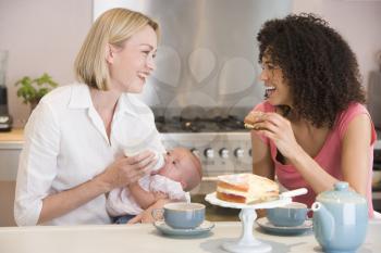 Royalty Free Photo of Two Women and a Baby in a Kitchen