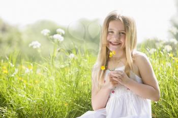 Royalty Free Photo of a Girl Picking Flowers
