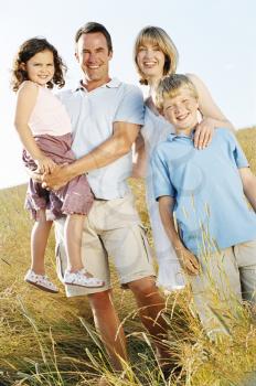 Royalty Free Photo of a Family Standing in a Field