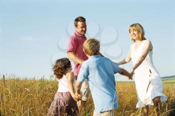 Royalty Free Photo of a Family Playing Outside