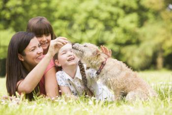 Royalty Free Photo of a Mother and Daughters With a Dog