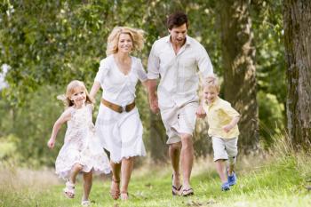 Royalty Free Photo of a Family Running on a Path