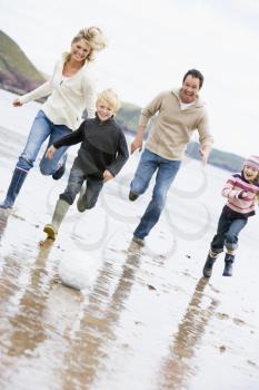 Royalty Free Photo of a Family Running at the Beach