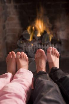Royalty Free Photo of Children's Feet at a Fireplace