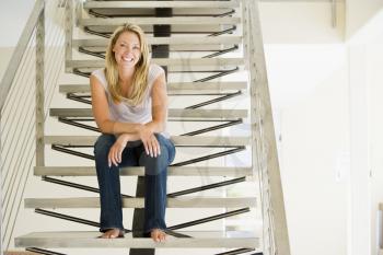 Royalty Free Photo of a Woman Sitting on a Staircase