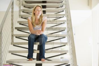 Royalty Free Photo of a Woman Sitting on the Stairs