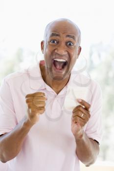 Royalty Free Photo of a Man With a Winning Lottery Ticket