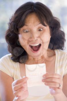 Royalty Free Photo of a Woman With a Winning Lottery Ticket