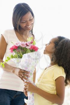 Royalty Free Photo of a Girl Giving Her Mother Flowers