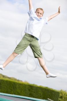 Royalty Free Photo of a Boy Jumping on a Trampoline