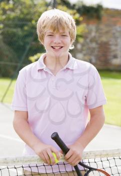 Royalty Free Photo of a Boy on a Tennis Court