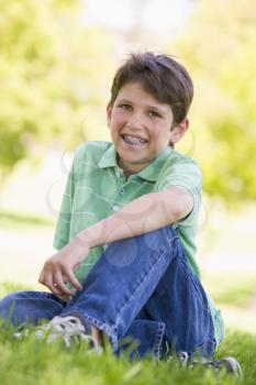 Royalty Free Photo of a Boy Sitting Outside