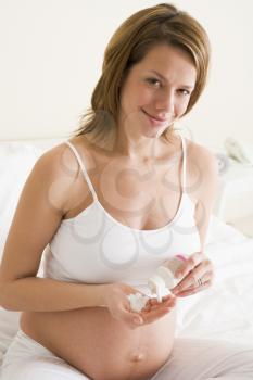 Royalty Free Photo of a Pregnant Woman Taking Medication