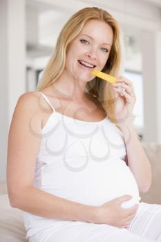 Royalty Free Photo of a Pregnant Woman Eating Melon