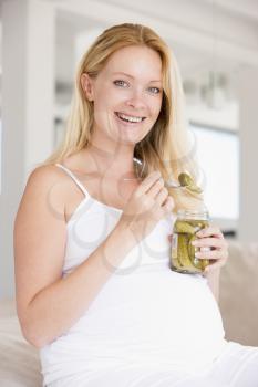 Royalty Free Photo of a Pregnant Woman Eating Pickles