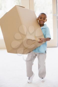 Royalty Free Photo of a Young Boy Holding a Box
