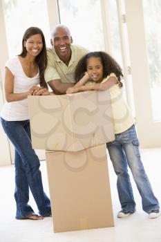 Royalty Free Photo of a Family Besides Boxes