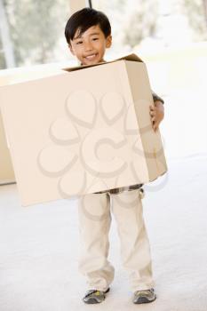 Royalty Free Photo of a Little Boy With a Big Box