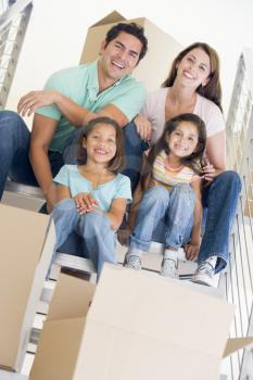 Royalty Free Photo of a Family Sitting on a Staircase