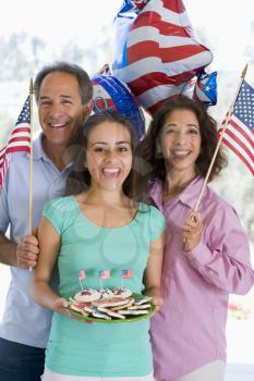 Royalty Free Photo of a Family With American Flags and Cookies