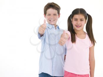 Royalty Free Photo of a Brother and Sister Giving Thumbs Up