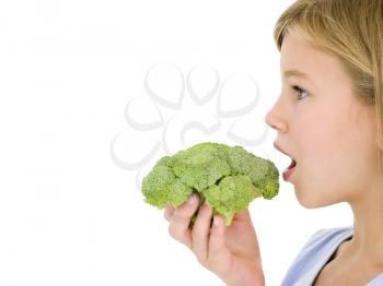 Royalty Free Photo of a Girl Eating Broccoli