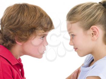 Royalty Free Photo of a Brother and Sister Staring at Each Other