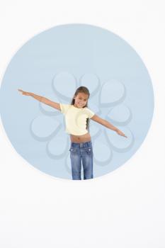 Royalty Free Photo of a Girl Standing With Her Arms Out