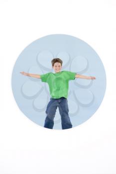 Royalty Free Photo of a Boy Jumping With His Arms Out