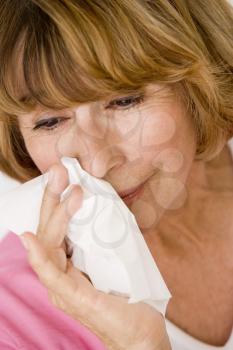 Royalty Free Photo of a Woman Blowing Her Nose