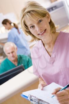 Royalty Free Photo of a Nurse at a Reception Area