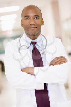 Royalty Free Photo of a Doctor Standing in a Corridor