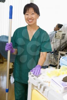 Royalty Free Photo of a Woman Mopping the Floor of a Hospital