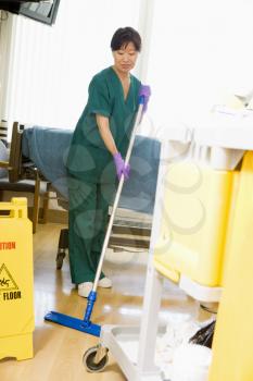 Royalty Free Photo of an Orderly Mopping the Floor