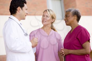 Royalty Free Photo of a Doctor Talking to Two Nurses