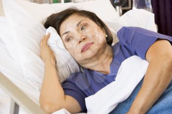 Royalty Free Photo of a Woman in a Hospital Bed