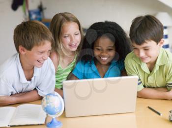 Royalty Free Photo of a Group of Children With a Laptop