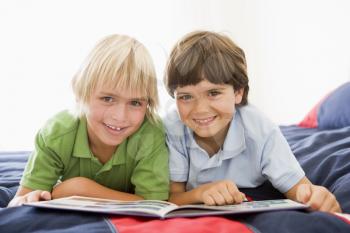 Royalty Free Photo of Two Boys Reading a Book