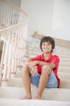 Royalty Free Photo of a Little Boy Sitting on the Stairs